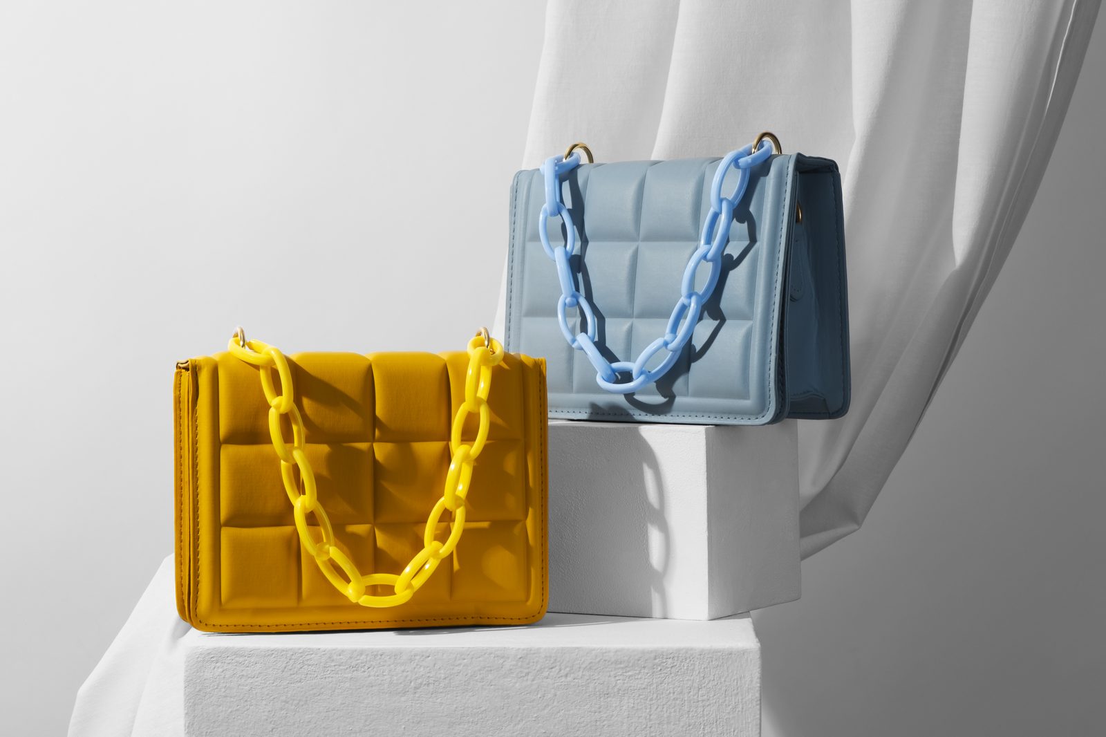 Two quilted handbags with chain straps